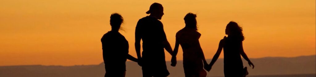 a brazilian family of family standing in a sunset