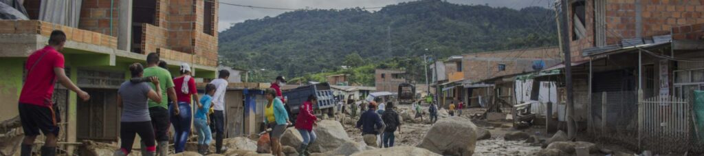 people-walking-stones-landslide-by-houses (1)